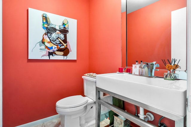 bathroom with toilet and tile patterned flooring