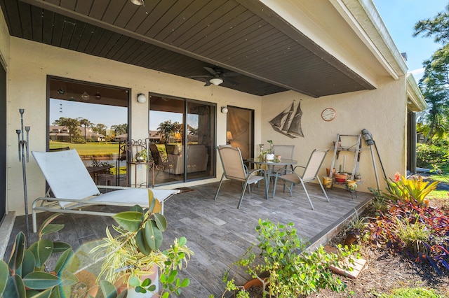 wooden deck featuring ceiling fan and outdoor dining space