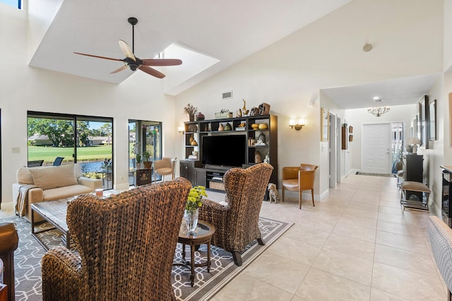 living room featuring high vaulted ceiling, visible vents, baseboards, ceiling fan, and light tile patterned floors