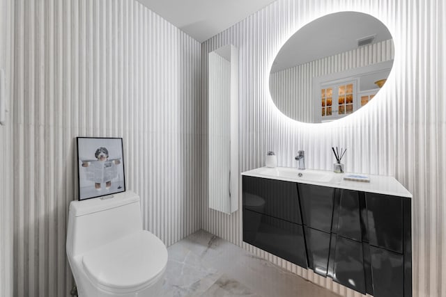 17888 Fieldbrook Cir W, Boca Raton, FL 33496 - half bath featuring wallpapered walls, toilet, marble tiled flooring, and vanity