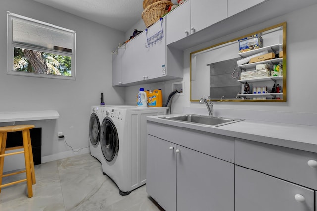 17888 Fieldbrook Cir W, Boca Raton, FL 33496 - clothes washing area with cabinet space, washing machine and dryer, light marble finish flooring, and baseboards