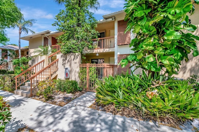 view of property featuring a fenced front yard and stairs