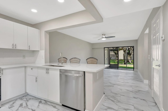 kitchen featuring a sink, dishwasher, a ceiling fan, and light countertops