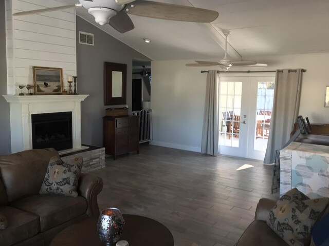 living area featuring french doors, wood finished floors, radiator, and ceiling fan
