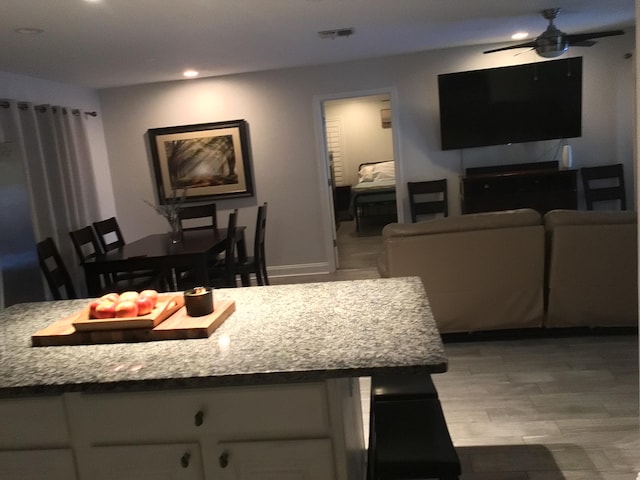 kitchen with light wood-style floors, ceiling fan, visible vents, white cabinets, and recessed lighting