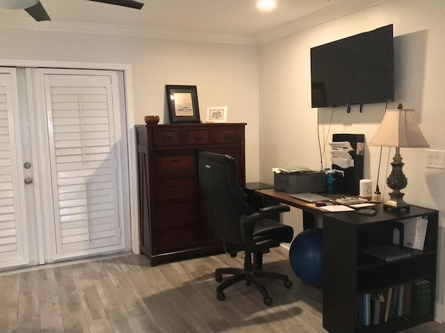 home office featuring light wood-type flooring and ornamental molding