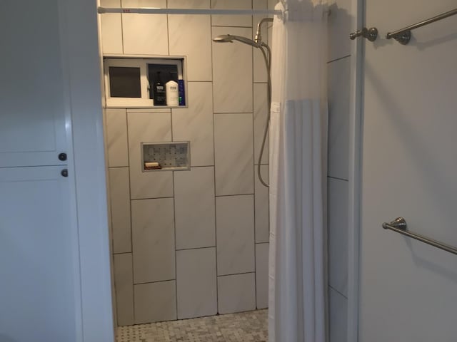 bathroom with tiled shower