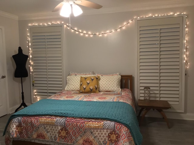 bedroom featuring crown molding, baseboards, and wood finished floors