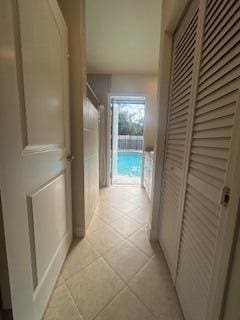 hall featuring light tile patterned floors