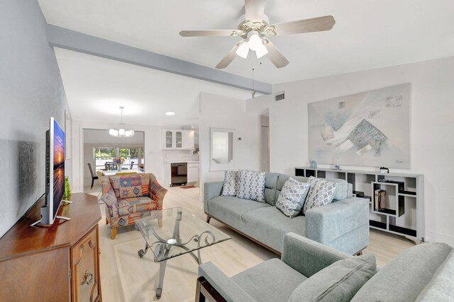 775 Sandia Ave, Port Saint Lucie, FL 34983 - living room with light wood-style flooring, visible vents, ceiling fan with notable chandelier, and lofted ceiling