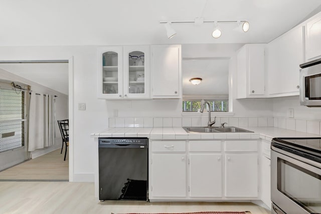 775 Sandia Ave, Port Saint Lucie, FL 34983 - kitchen featuring tile countertops, a sink, white cabinets, and stainless steel appliances