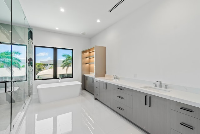 368 Churchill Rd, West Palm Beach, FL 33405 - full bath with a soaking tub, recessed lighting, a stall shower, and a sink