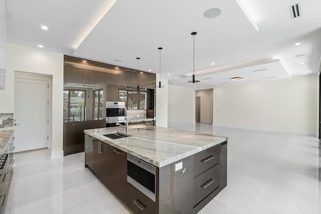368 Churchill Rd, West Palm Beach, FL 33405 - kitchen with modern cabinets, a sink, a spacious island, recessed lighting, and dark brown cabinetry