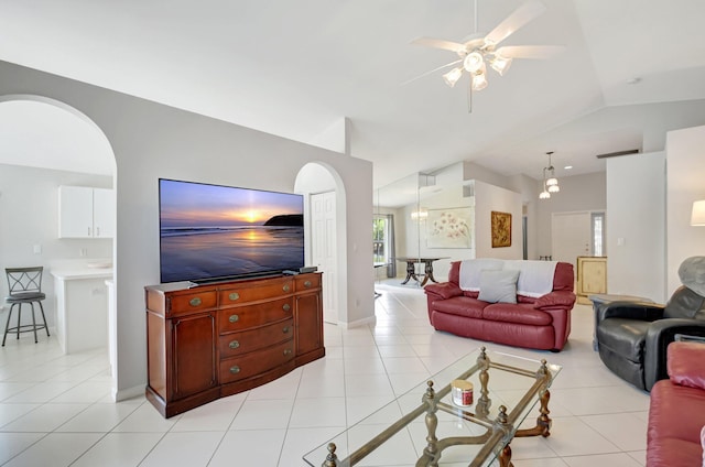 1744 Sawgrass Cir, Greenacres, FL 33413 - living area featuring light tile patterned floors, arched walkways, ceiling fan with notable chandelier, and vaulted ceiling