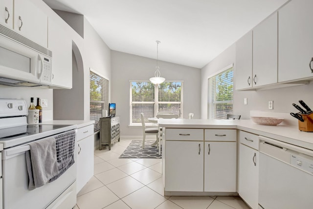 1744 Sawgrass Cir, Greenacres, FL 33413 - kitchen featuring light tile patterned flooring, light countertops, a peninsula, lofted ceiling, and white appliances