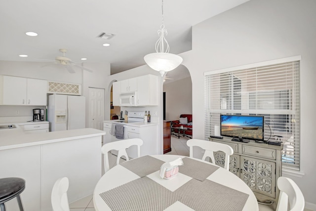 1744 Sawgrass Cir, Greenacres, FL 33413 - dining space featuring visible vents, ceiling fan, recessed lighting, arched walkways, and light tile patterned floors
