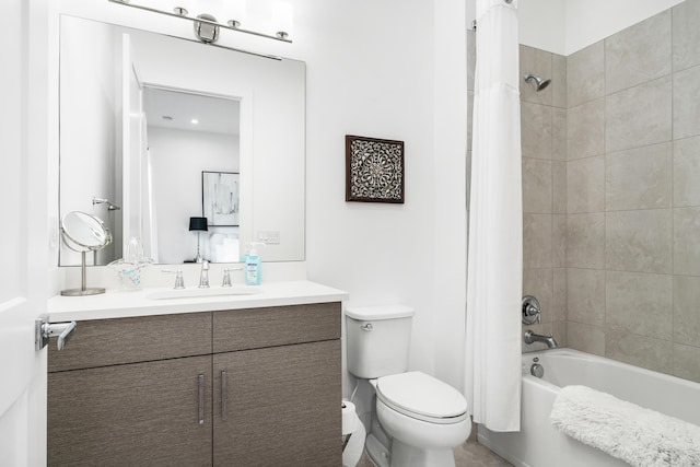 full bathroom featuring toilet, shower / tub combo with curtain, and vanity