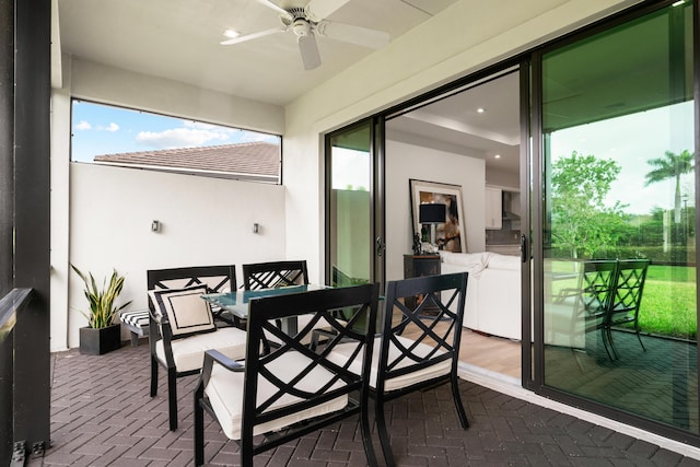 sunroom featuring a ceiling fan