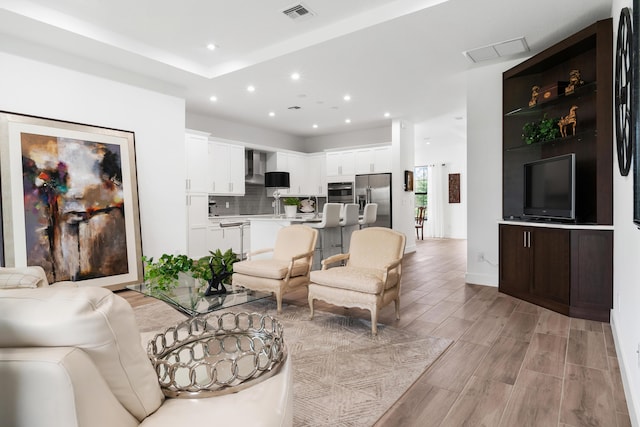 living room featuring recessed lighting, visible vents, and wood tiled floor