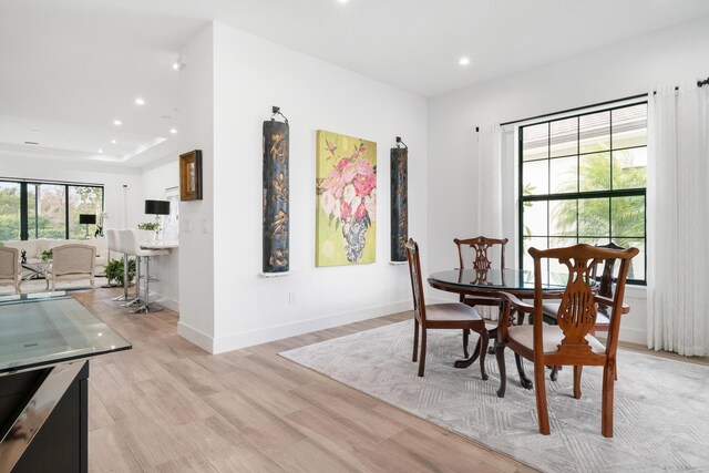 dining area featuring recessed lighting, baseboards, and light wood finished floors