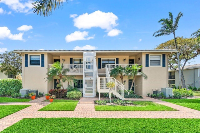 9 Stratford Dr Unit D, Boynton Beach, FL 33436 - view of building exterior with central air condition unit and stairs