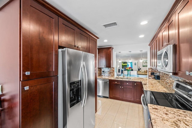 9 Stratford Dr Unit D, Boynton Beach, FL 33436 - kitchen featuring visible vents, pendant lighting, light stone counters, decorative backsplash, and stainless steel appliances