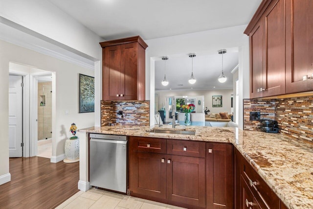 9 Stratford Dr Unit D, Boynton Beach, FL 33436 - kitchen featuring a sink, light stone counters, stainless steel dishwasher, and crown molding