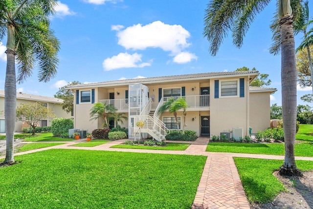 9 Stratford Dr Unit D, Boynton Beach, FL 33436 - view of building exterior featuring stairs and cooling unit