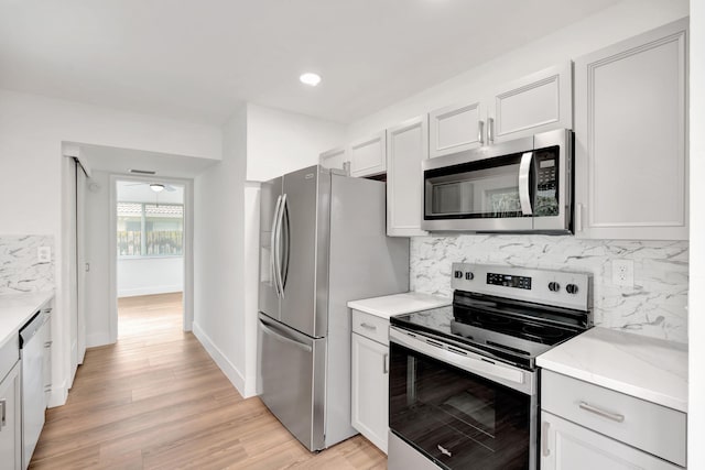 12938 Ellison Wilson Rd, North Palm Beach, FL 33408 - kitchen featuring stainless steel appliances, backsplash, light wood finished floors, baseboards, and recessed lighting