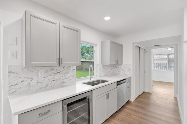 12938 Ellison Wilson Rd, North Palm Beach, FL 33408 - kitchen with beverage cooler, a sink, stainless steel dishwasher, backsplash, and light countertops