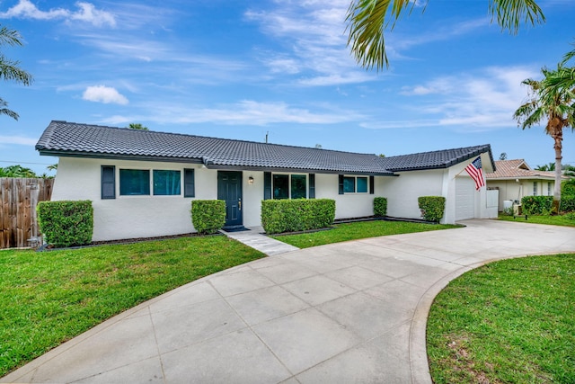 12938 Ellison Wilson Rd, North Palm Beach, FL 33408 - ranch-style house with driveway, stucco siding, a tile roof, and an attached garage