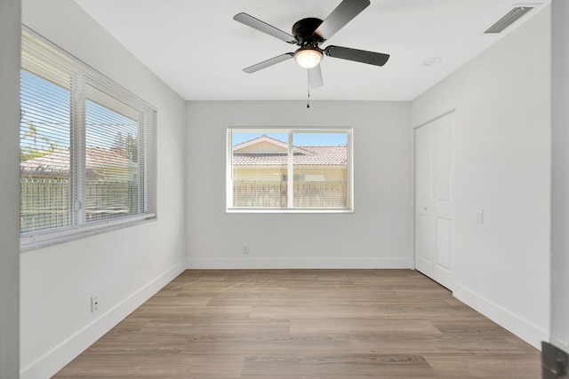 12938 Ellison Wilson Rd, North Palm Beach, FL 33408 - unfurnished room featuring a ceiling fan, light wood-style floors, and baseboards