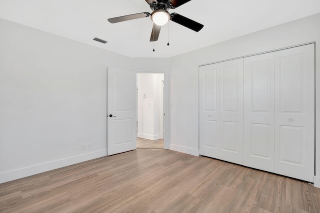 12938 Ellison Wilson Rd, North Palm Beach, FL 33408 - unfurnished bedroom featuring light wood-style floors, baseboards, a closet, and ceiling fan
