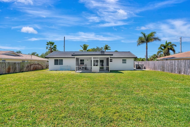12938 Ellison Wilson Rd, North Palm Beach, FL 33408 - rear view of property featuring a sunroom, stucco siding, and a tiled roof
