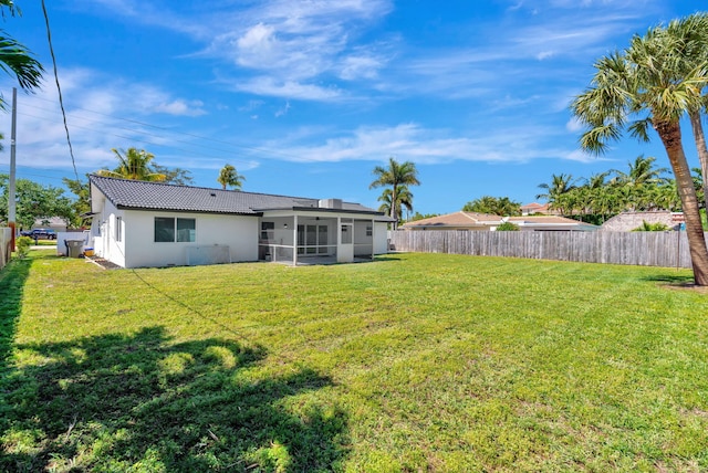 12938 Ellison Wilson Rd, North Palm Beach, FL 33408 - rear view of house with stucco siding, a sunroom, and a tiled roof