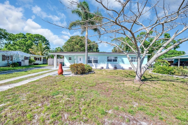 332 Smallwood Ave, Fort Pierce, FL 34982 - ranch-style home featuring a front lawn, a carport, and driveway