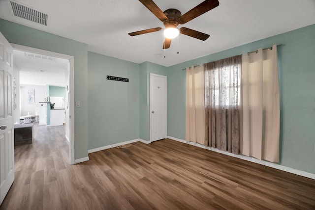 332 Smallwood Ave, Fort Pierce, FL 34982 - spare room with visible vents, baseboards, a ceiling fan, and wood finished floors