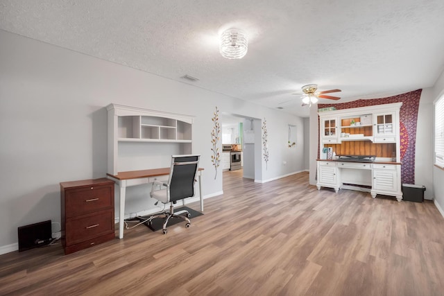332 Smallwood Ave, Fort Pierce, FL 34982 - unfurnished office featuring a ceiling fan, light wood-style floors, baseboards, and a textured ceiling