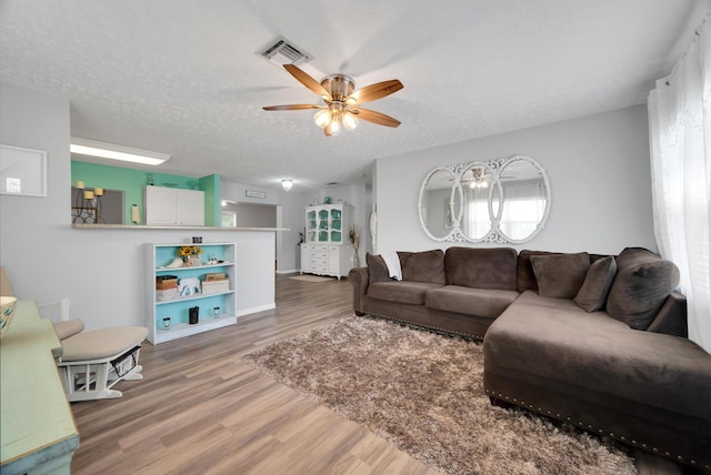 332 Smallwood Ave, Fort Pierce, FL 34982 - living room with light wood-type flooring, a ceiling fan, visible vents, and a textured ceiling