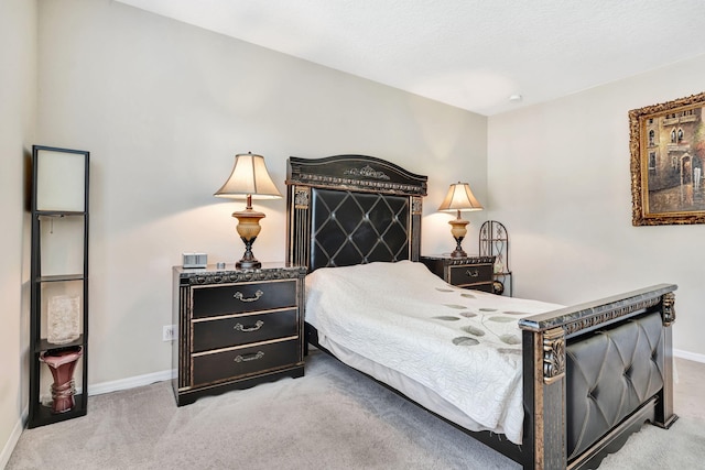 bedroom featuring carpet and baseboards