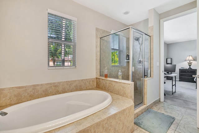 bathroom with a wealth of natural light, a bath, a shower stall, and tile patterned flooring