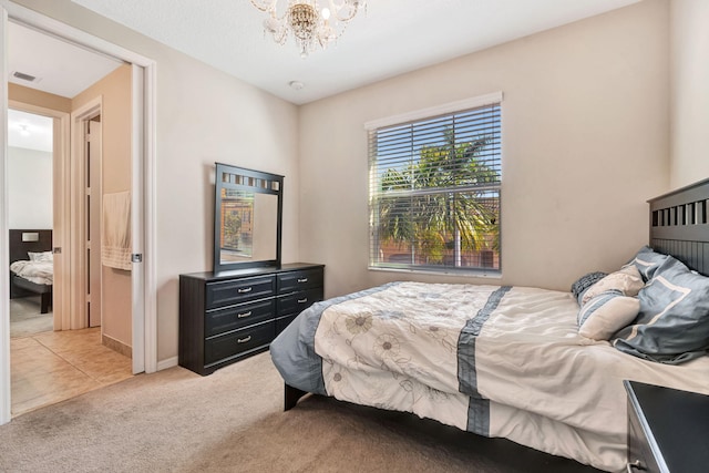 bedroom with visible vents, light carpet, a notable chandelier, light tile patterned flooring, and baseboards