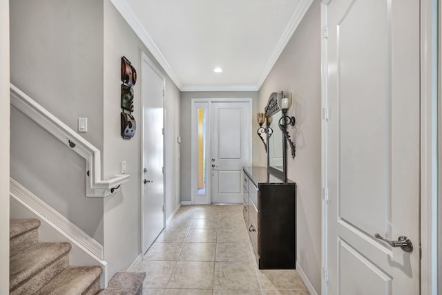 foyer featuring stairway, baseboards, and ornamental molding