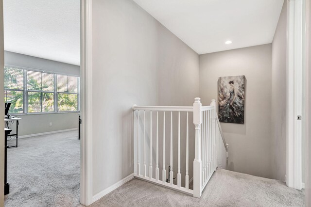 hall featuring an upstairs landing, recessed lighting, baseboards, and carpet