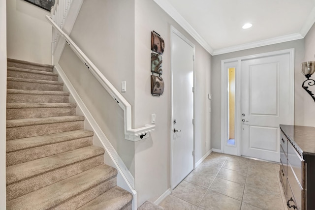 entrance foyer featuring stairs, crown molding, light tile patterned floors, and baseboards