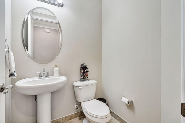 bathroom featuring toilet and baseboards
