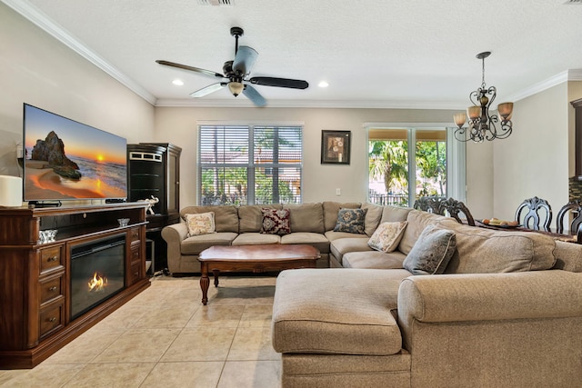living area featuring ceiling fan with notable chandelier, light tile patterned floors, a healthy amount of sunlight, and ornamental molding