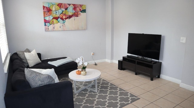 living room with light tile patterned floors and baseboards