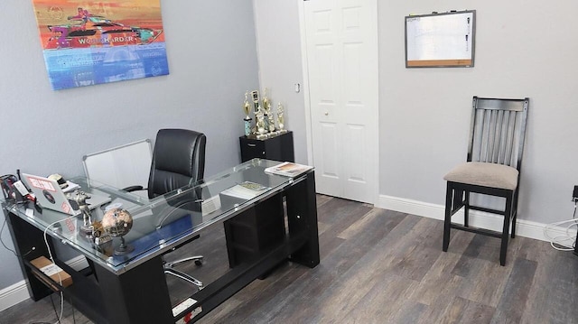 office area featuring baseboards and dark wood-type flooring