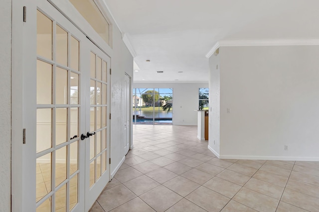 hallway with french doors, light tile patterned floors, baseboards, and ornamental molding